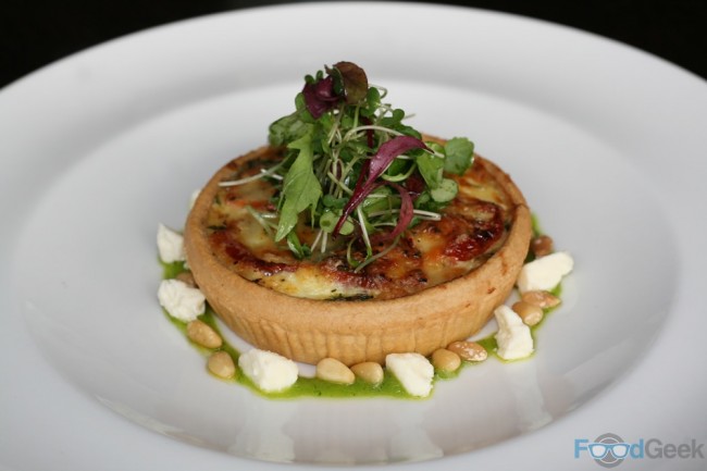 Warm caramelised onion and tomato quiche, rocket pesto, Leagram’s Lancashire curd cheese, pine nuts